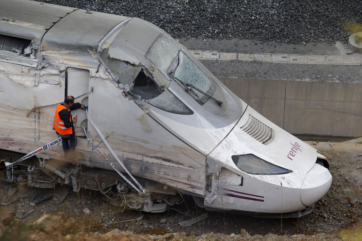 A rail personnel worker checks the cabin of a derailed train following an accident in Santiago de Compostela, Spain, on July 25.