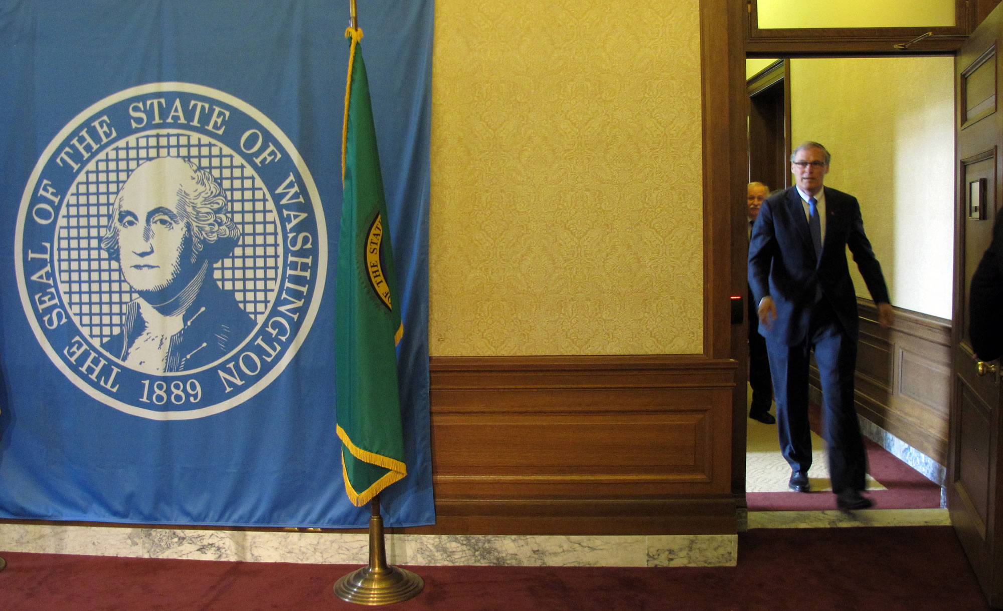 Gov. Jay Inslee arrives to announce a legislative budget deal, on Thursday in Olympia.