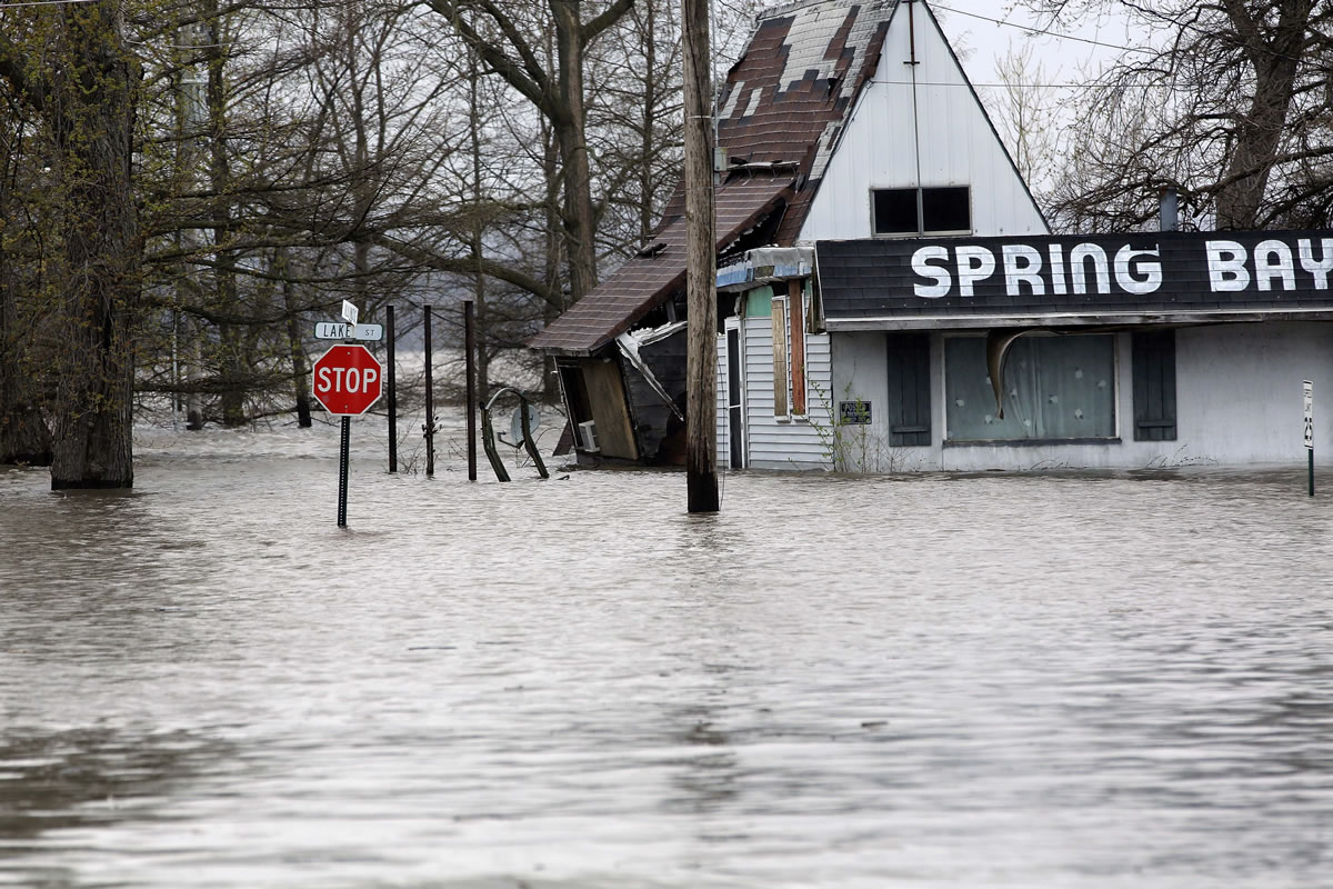 The Illinois River rises out of it's banks, flooding businesses and homes Tuesday in Spring Bay Ill.