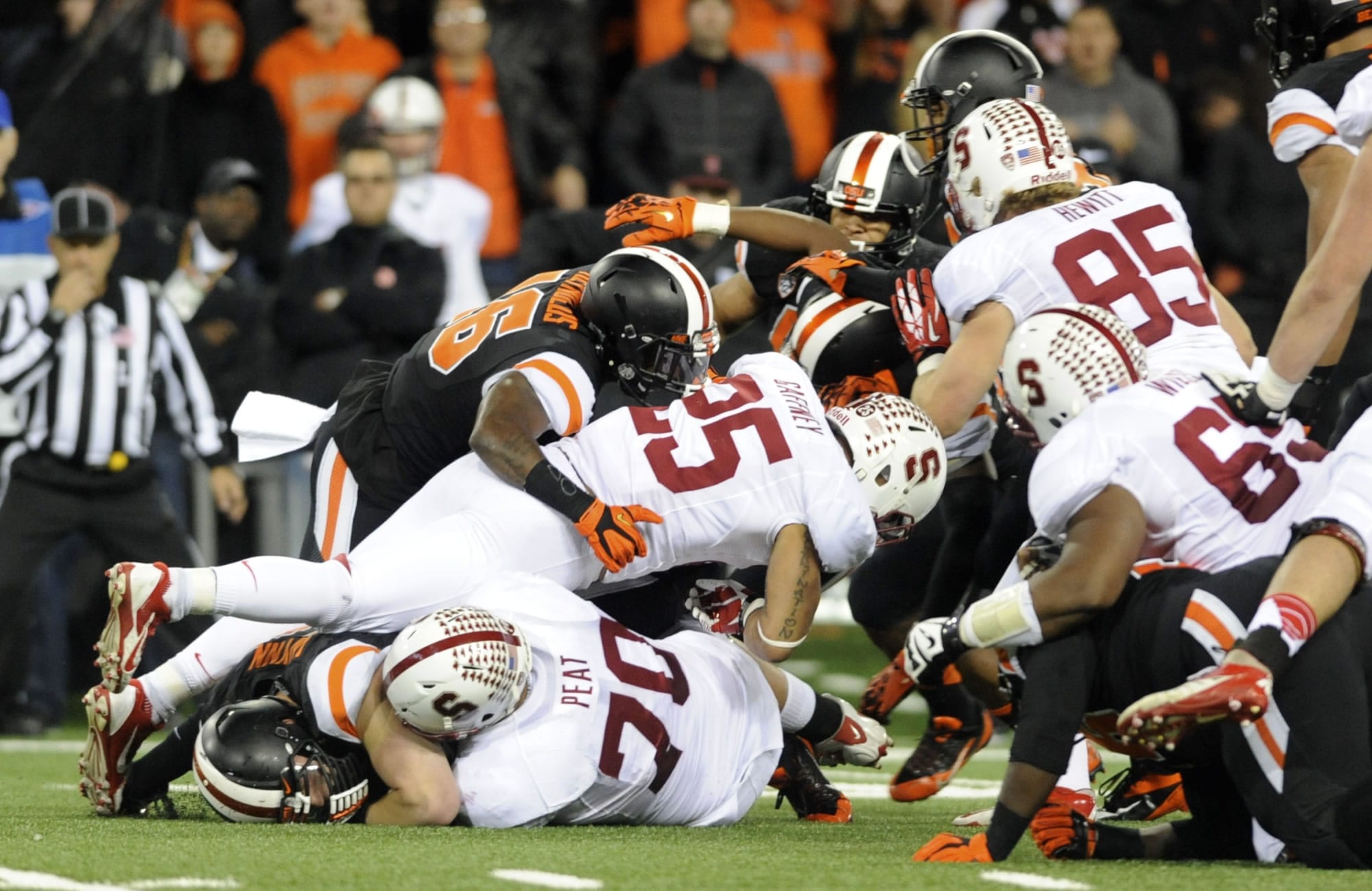Stanford's Tyler Gaffney (25) works against Oregon State defenders during the first half of an NCAA college football game in Corvallis, Ore., Saturday Oct. 26, 2013.