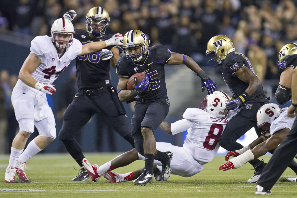 Washington's Bishop Sankey gets past Stanford defenders on a 61-yard touchdown during the third quarter Thursday.
