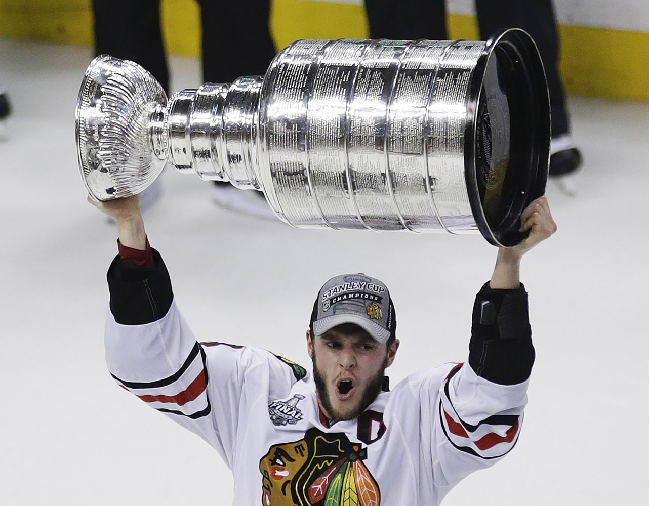 Stanley Cup Final MVP Patrick Kane hoists the Stanley Cup after beating the Boston Bruins 3-2 in Game 6 of the Stanley Cup Final on Monday.