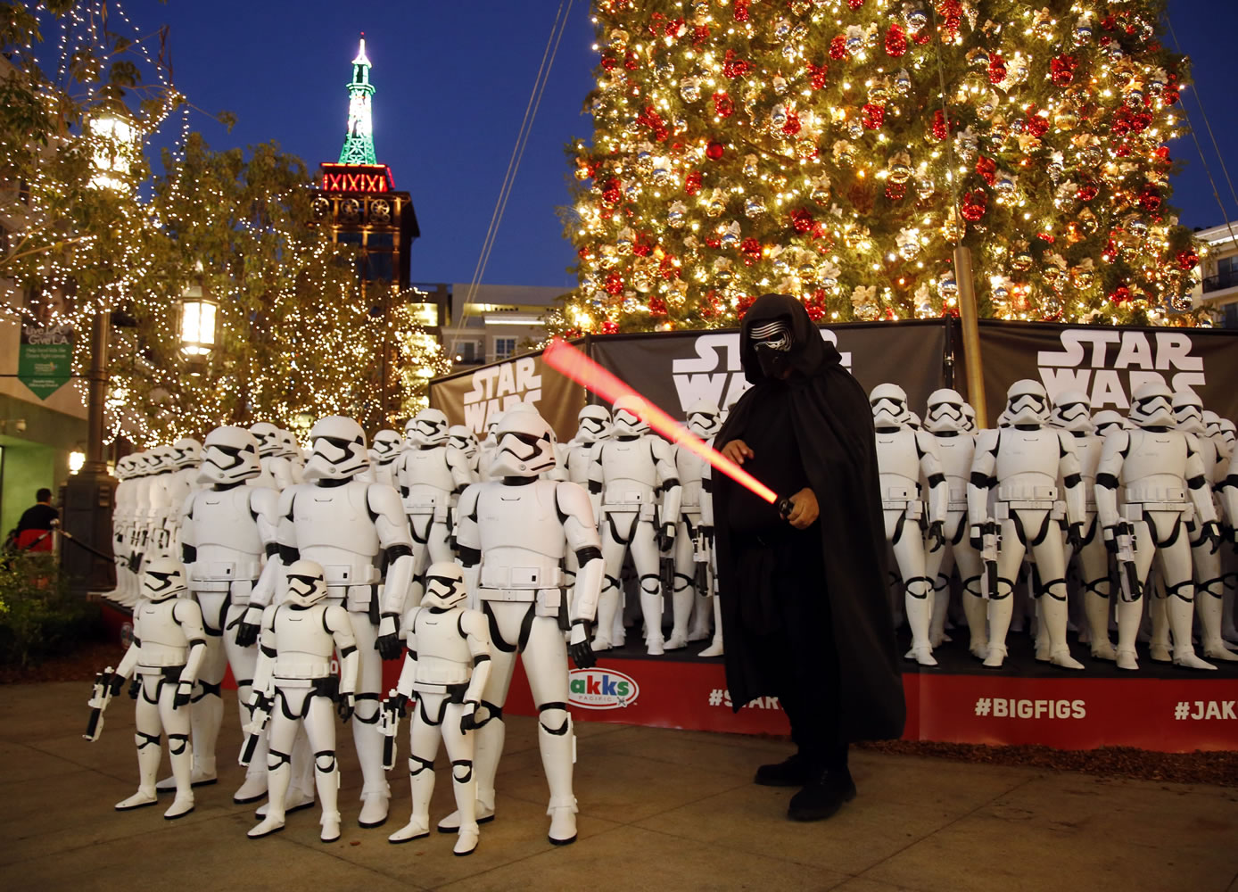Isaac Islas from Eagle Rock, Calif. poses for a photo Thursday with more than 100 JAKKS BIG-FIGS Stormtrooper action figures as a part of an installation at The Americana at Brand for the opening of &quot;Star Wars: The Force Awakens&quot; in Glendale, Calif.