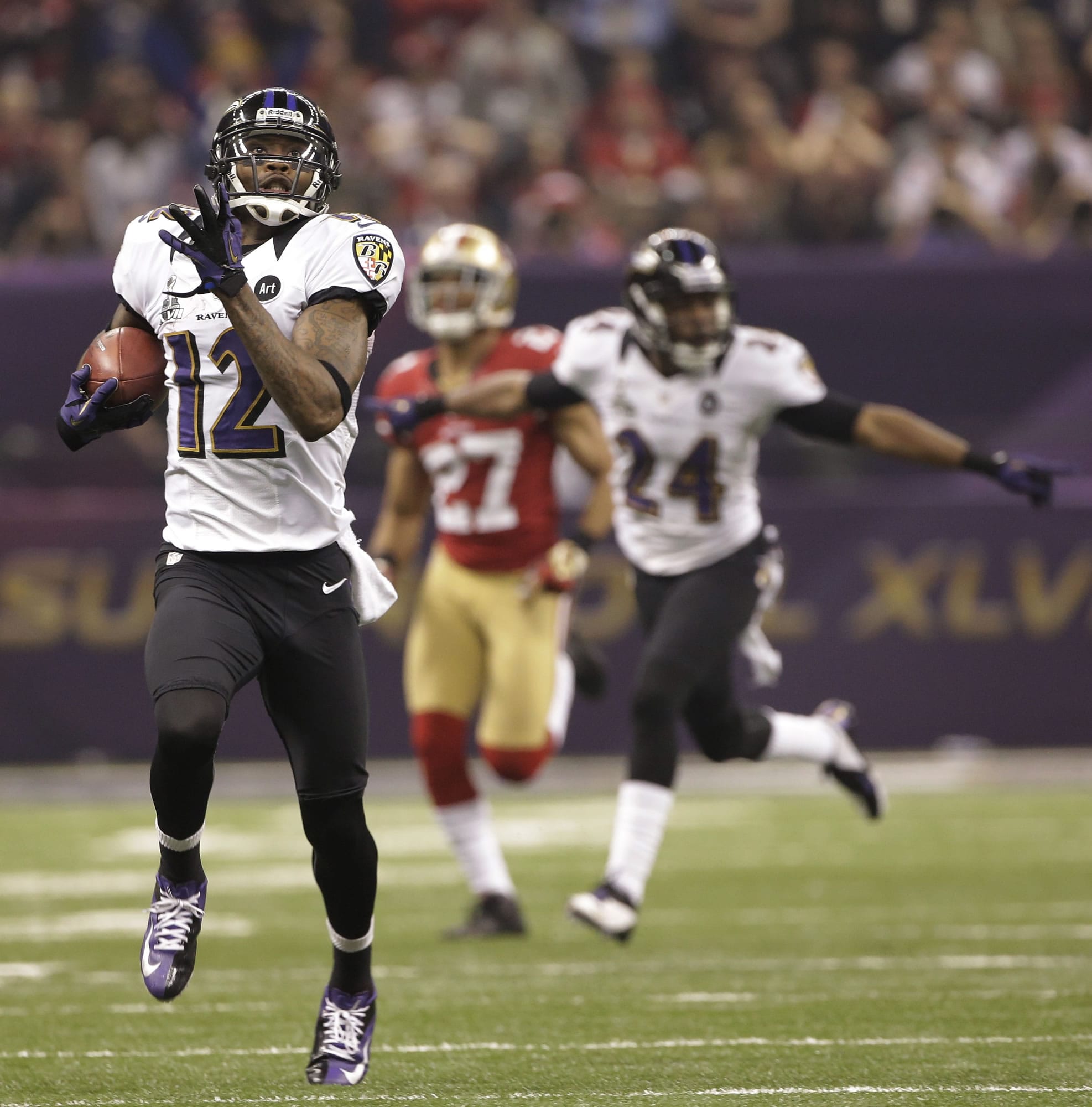 Baltimore's Jacoby Jones (12) takes the opening kickoff of the second half 108 yards for a touchdown.