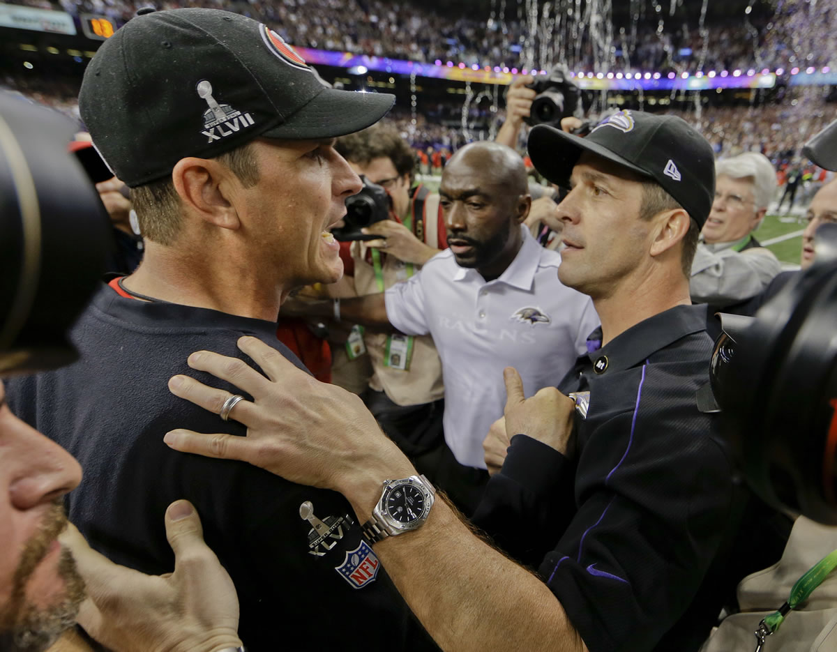San Francisco 49ers head coach Jim Harbaugh, left, greets Baltimore Ravens head coach John Harbaugh after the Ravens defeated the 49ers 34-31 in Super Bowl XLVII on Sunday.