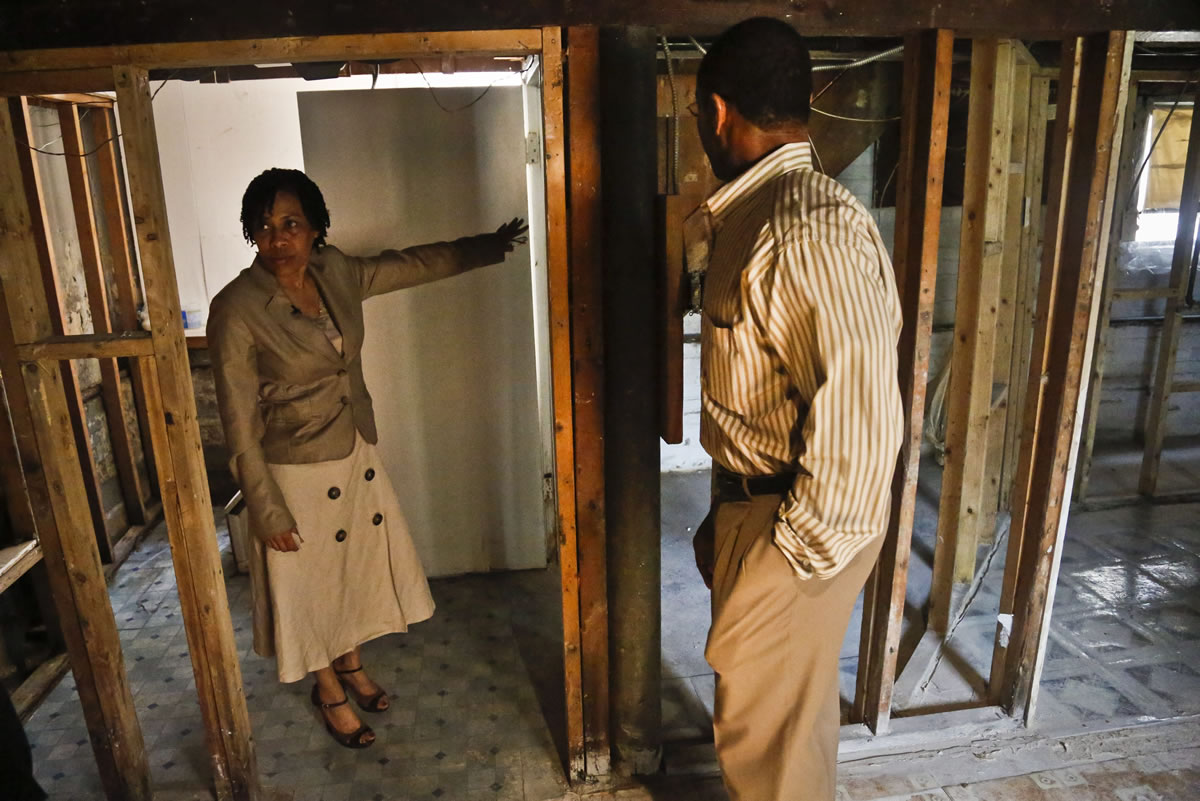 Yvonne Rankine, left, and her husband, the Rev. Trevor Rankine, tour the basement of their home in New York.