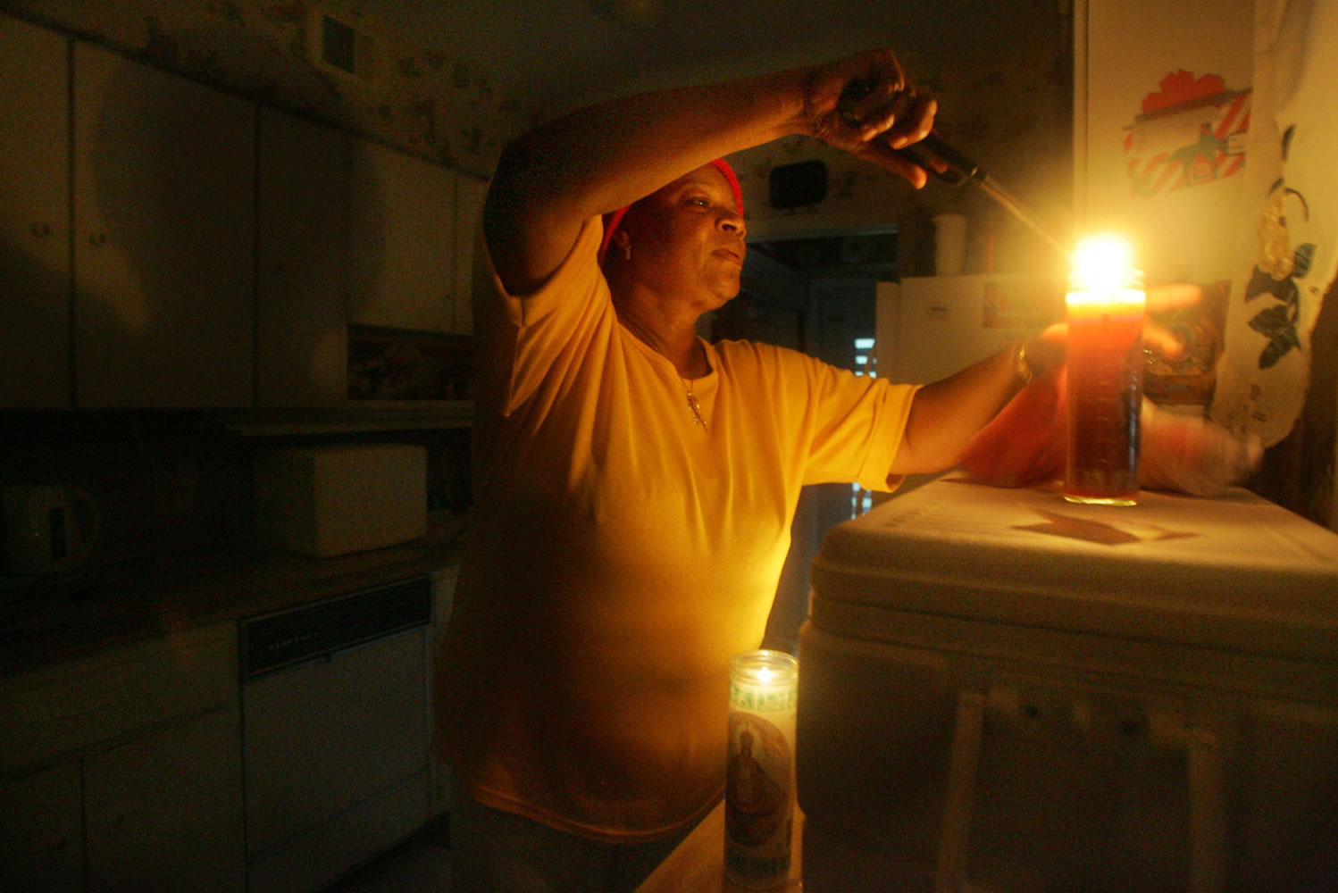 Minet Watson lights a candle in her home in Miami Shores, Fla., after Hurricane Katrina knocked out power in 2005.