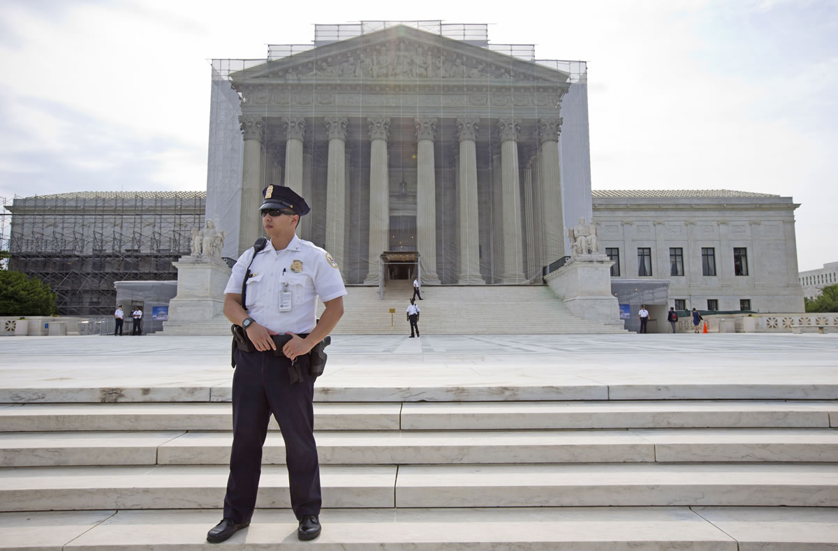 A police officer keeps watch outside the Supreme Court in Washington on Monday.