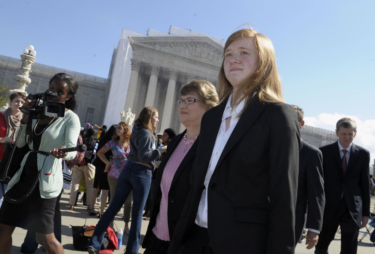 Abigail Fisher, right, who sued the University of Texas, walks outside the Supreme Court in Washington on Oct. 10, 2012.