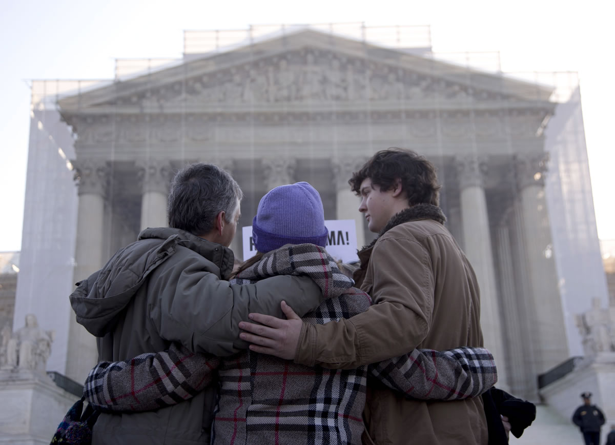A group from Alabama prays in front of the Supreme Court in Washington on Wednesday before the court's hearing on the Defense of Marriage Act.