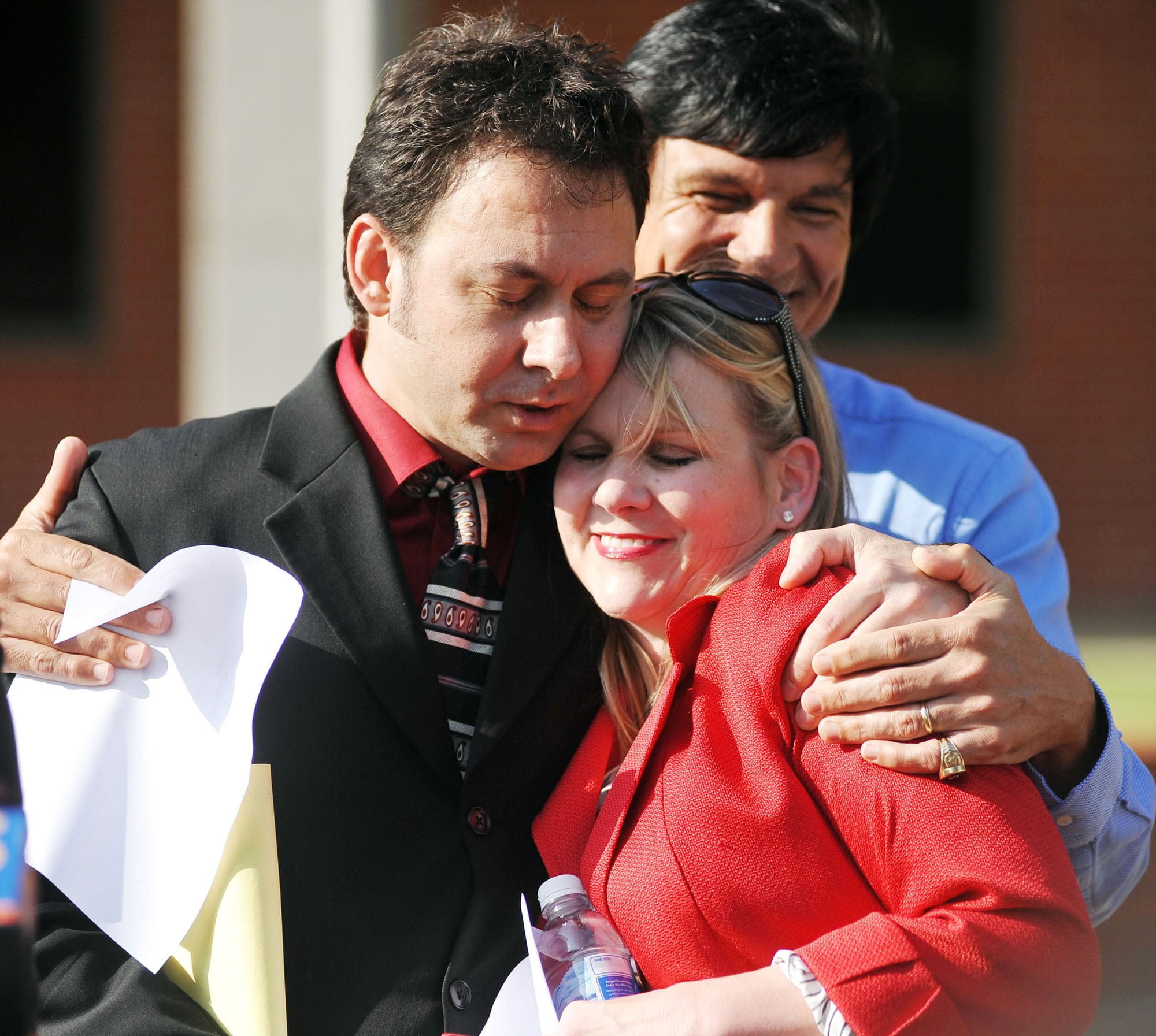 Paul Kevin Curtis, who had been in custody under suspicion of sending ricin-laced letters to President Barack Obama and others, left, hugs his attorney Christi McCoy during a news conference following his release  April 23 in Oxford, Miss.