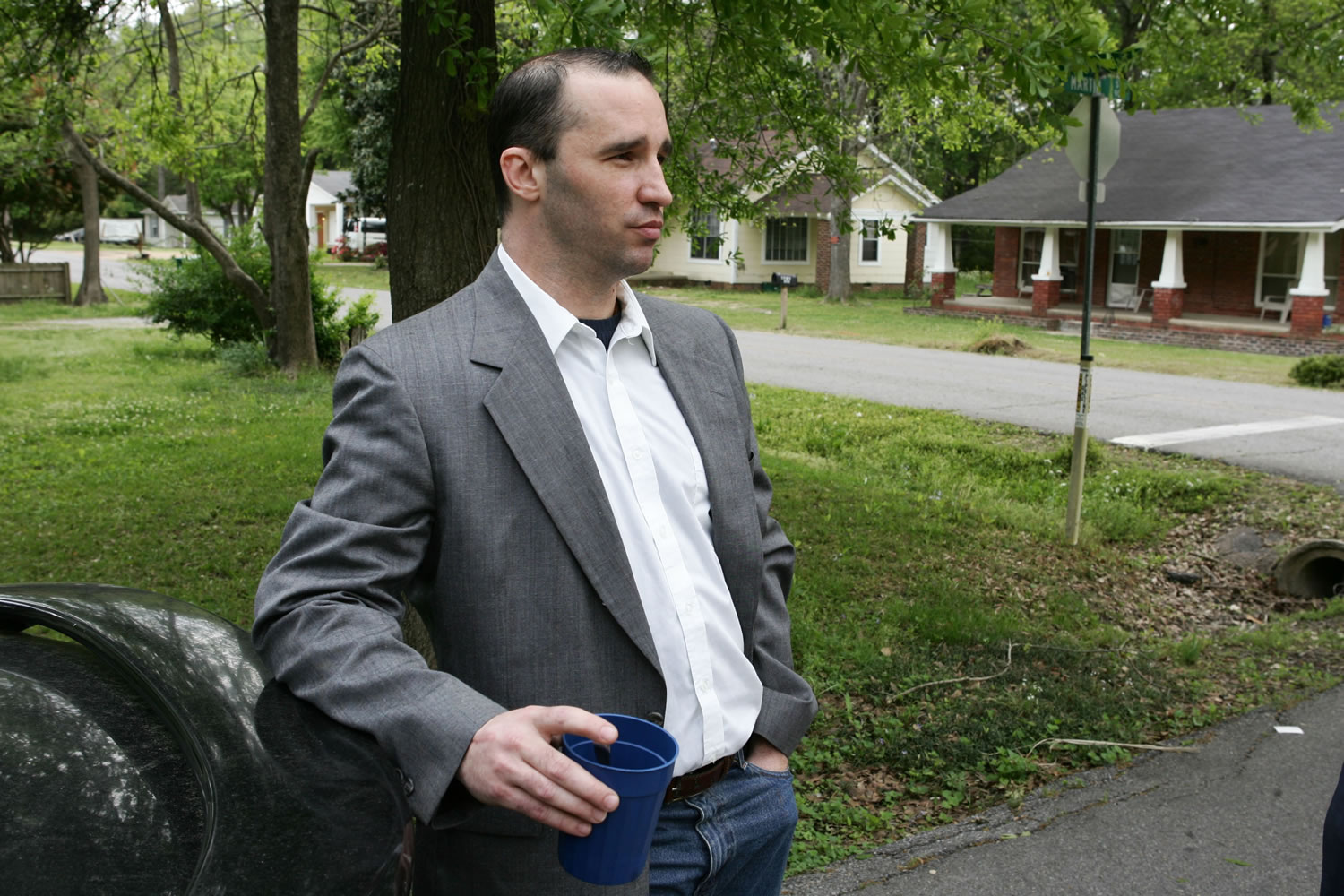 Everett Dutschke stands in the street near his home in Tupelo, Miss., and waits for the FBI to arrive and search his home last week.