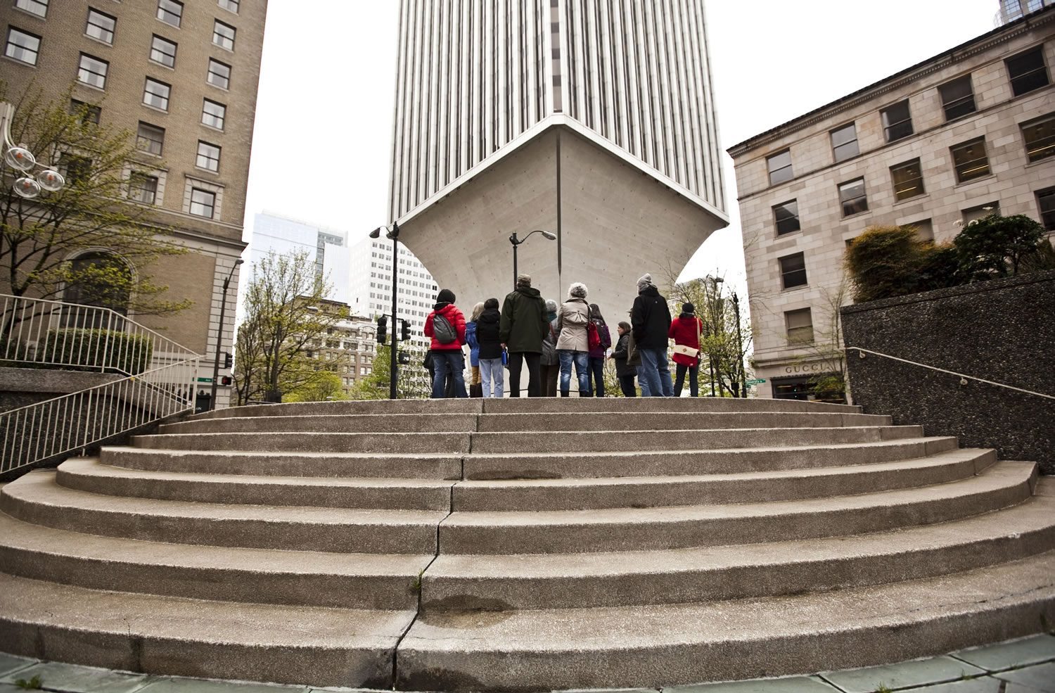 A recent tour given by the Seattle Architecture Foundation pauses at the foot of the Rainier Tower, designed by Minoru Yamasaki, the Seattle-born architect best known for designing the twin towers of the World Trade Center in New York City.