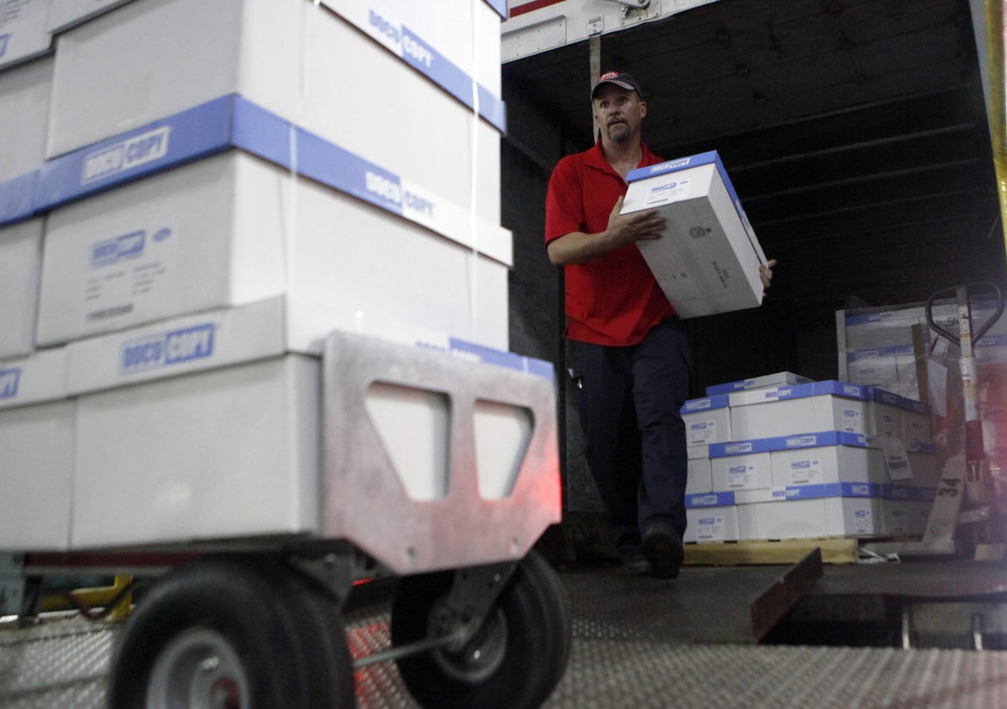 An SAIA employee unloads copy paper from a delivery truck Friday at Centennial Tower in downtown Atlanta.