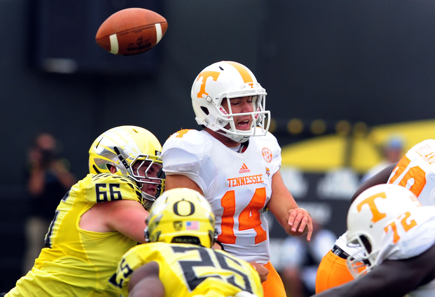 Tennessee quarterback Justin Worley (14) loses the ball as he is hit by Oregon defensive tackle Taylor Hart (66) during the second quarter Saturday in Eugene, Ore.