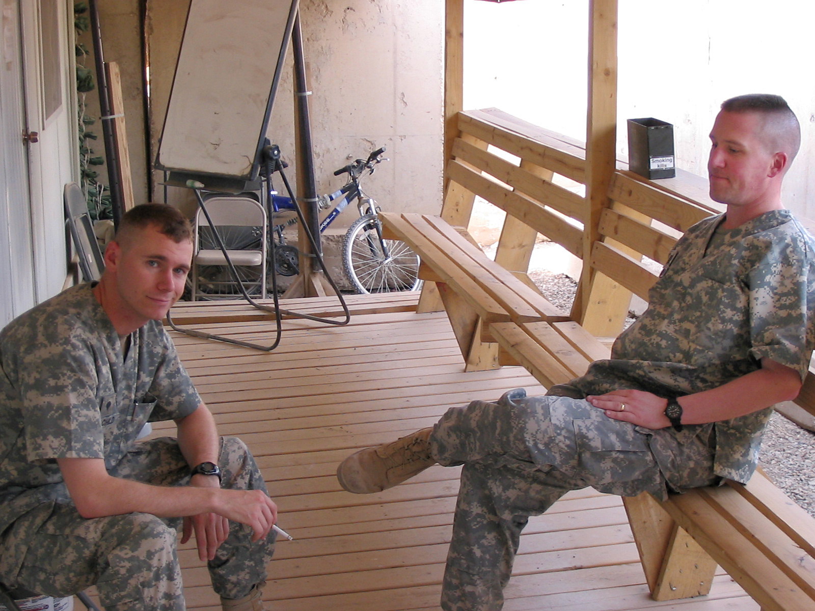 This 2007 photo provided by Brock McNabb shows Pete Linnerooth, right, and Travis Landchild sitting outside their mental health clinic in Baghdad. McNabb, Landchild and Linnerooth were the tight-knit mental health crew in charge of the 2nd Brigade Combat Team, 1st Infantry Division in the Baghdad area. They were there when the surge began, rocket attacks increased and the death toll mounted.