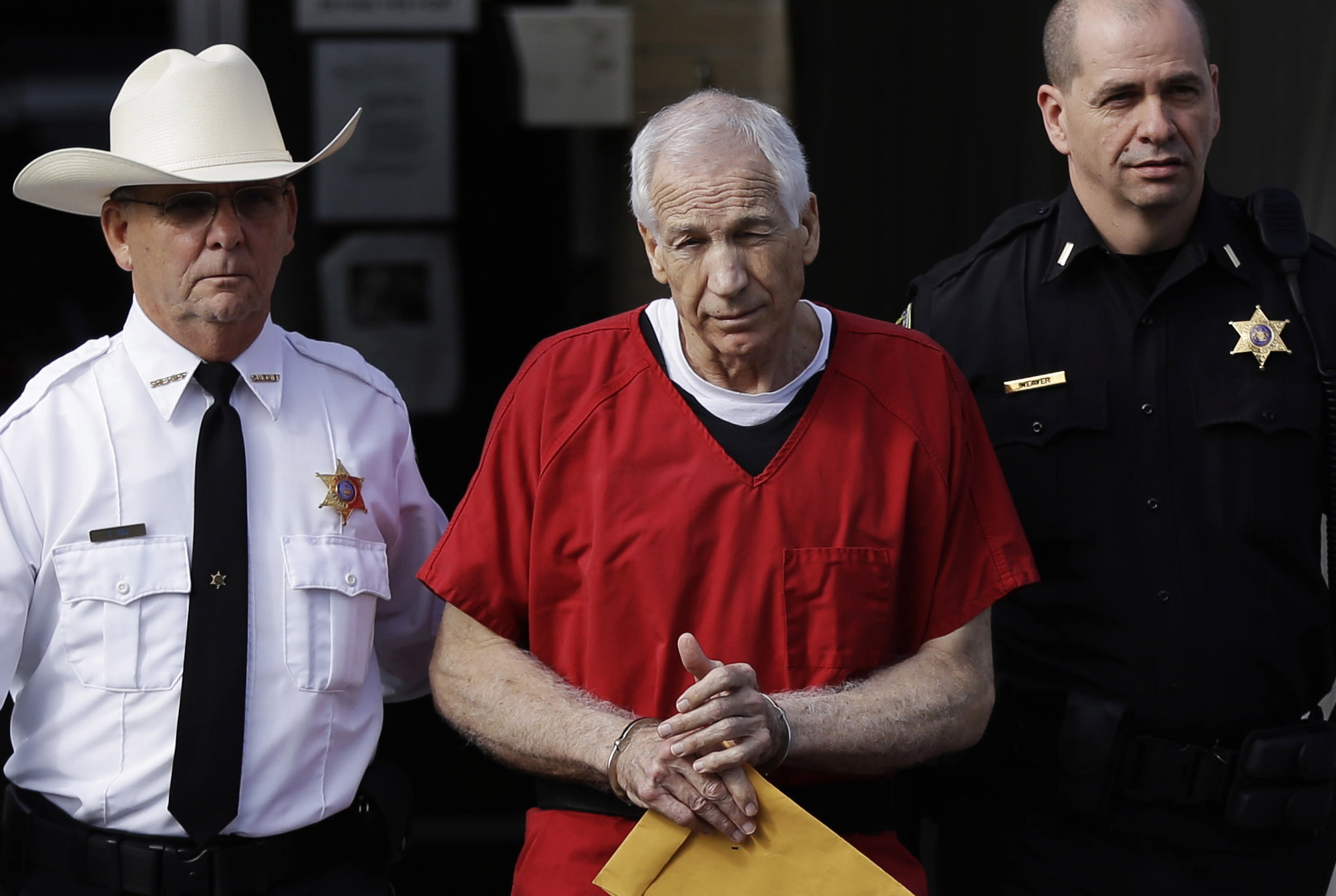 Associated Press files
Former Penn State University assistant football coach Jerry Sandusky, right, is taken from the Centre County Courthouse in Bellefonte, Pa., after being sentenced to at least 30 years in prison in October.