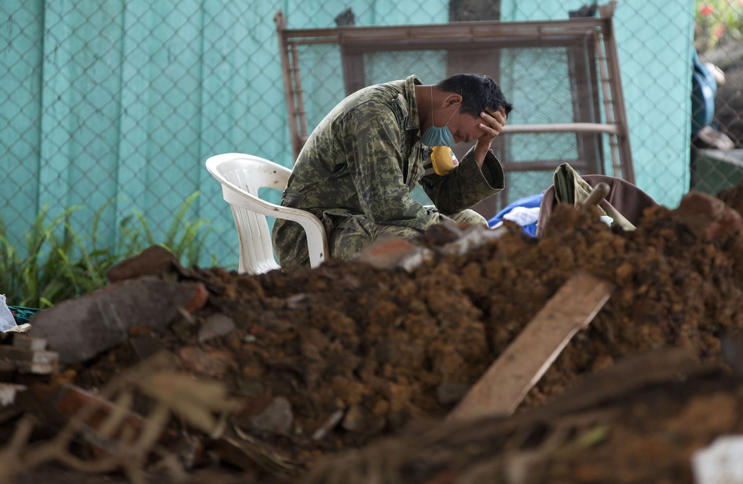 A soldier takes a break Sunday during the search for bodies in La Pintada, Mexico, where a landslide swept through the village center. La Pintada was the scene of the single greatest tragedy in the destruction wreaked by the twin storms, Manuel and Ingrid, which simultaneously pounded both of Mexico's coasts a week ago, spawning huge floods and landslides across a third of the country.