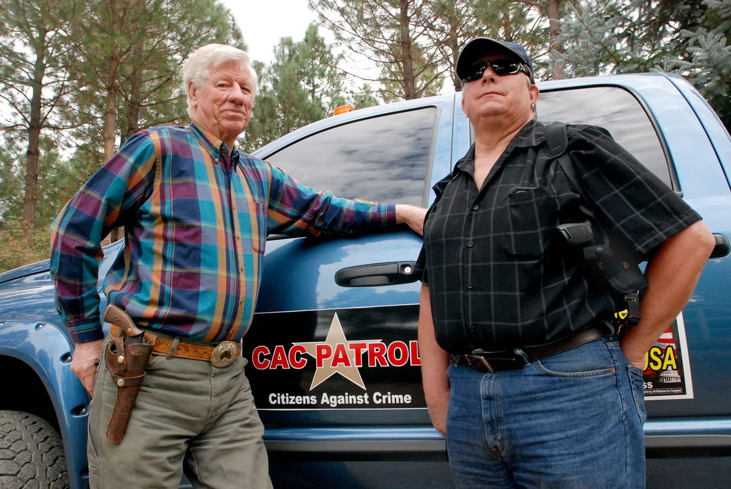 Photos by Jeff Barnard/Associated Press
Sam Nichols, left, and Glenn Woodbury stand in front of Woodbury's pickup in O'Brien, Ore. The two men are part of a newly-formed neighborhood watch that does armed patrols around the rural area to deter crime.