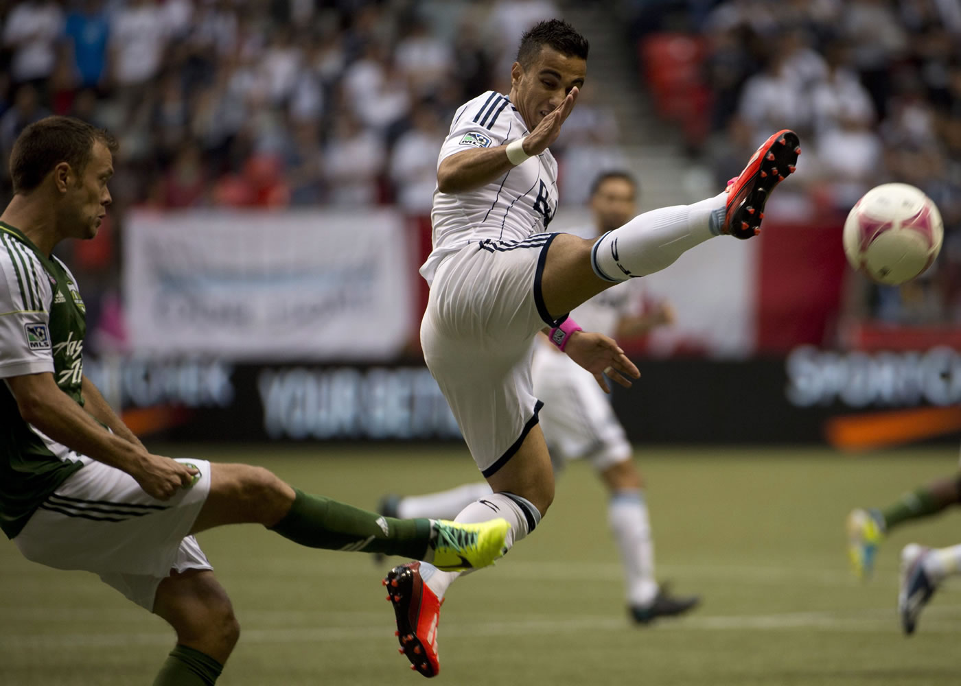 Vancouver Whitecaps Camilo Sanvezzo, right, fights for control of the ball with Portland Timbers Jack Jewsbury, left, during first half Sunday.