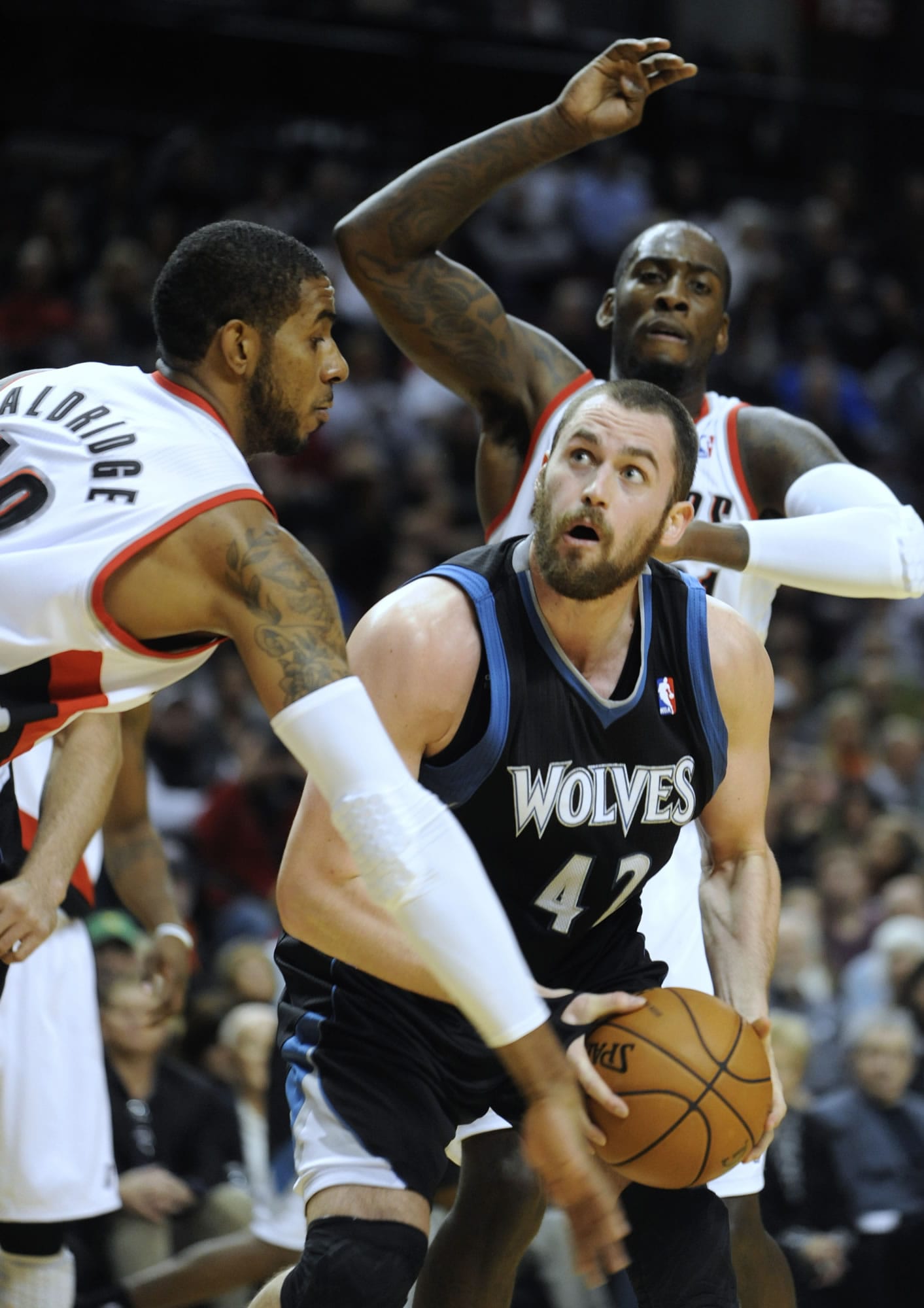 Minnesota Timberwolves' Kevin Love (42) looks to shoot against Portland Trail Blazers' J.J.