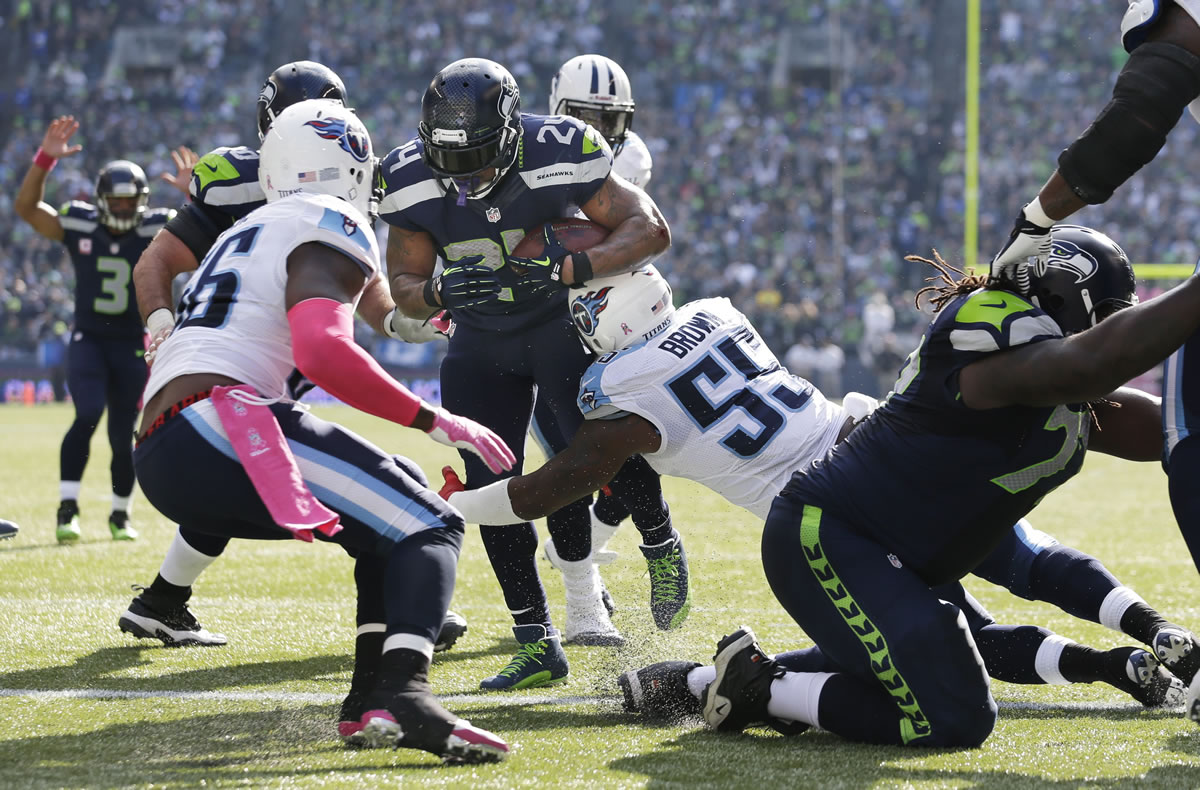 Seattle Seahawks Marshawn Lynch (24) breaks a tackle by outside linebacker Zach Brown (55) to run for a touchdown against the Tennessee Titans in the first half of an NFL football game, Sunday, Oct. 13, 2013, in Seattle.