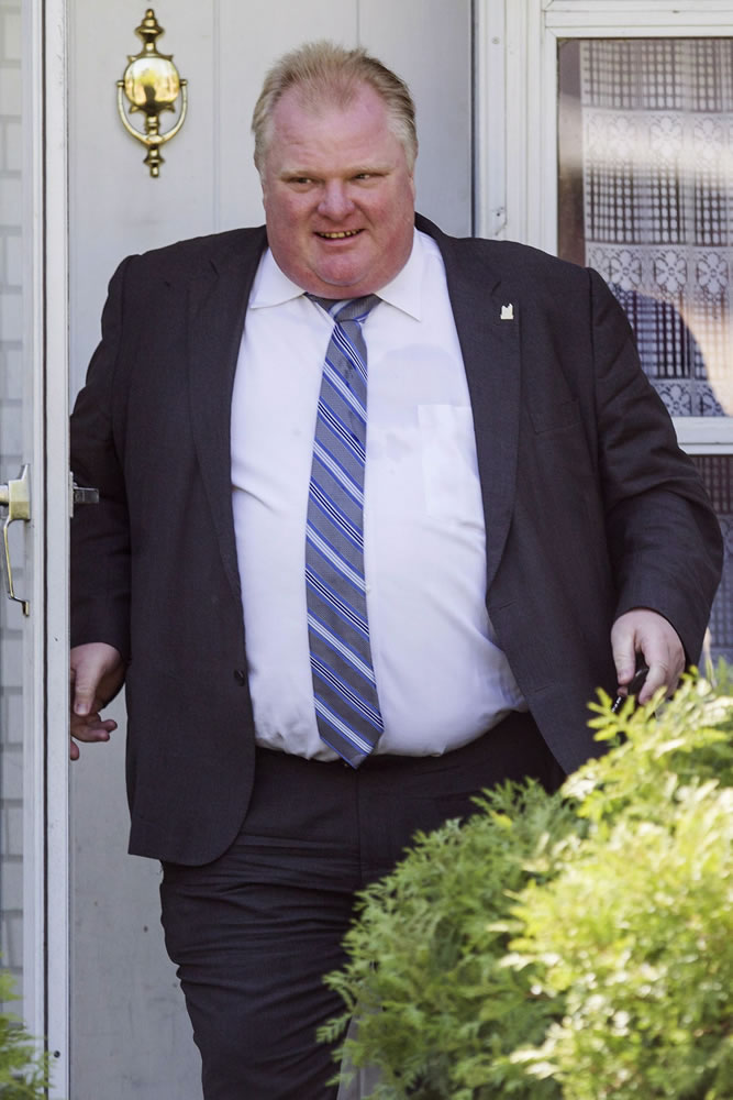 Toronto Mayor Rob Ford leaves his home Friday after published reports said a video appears to show Ford smoking crack cocaine.