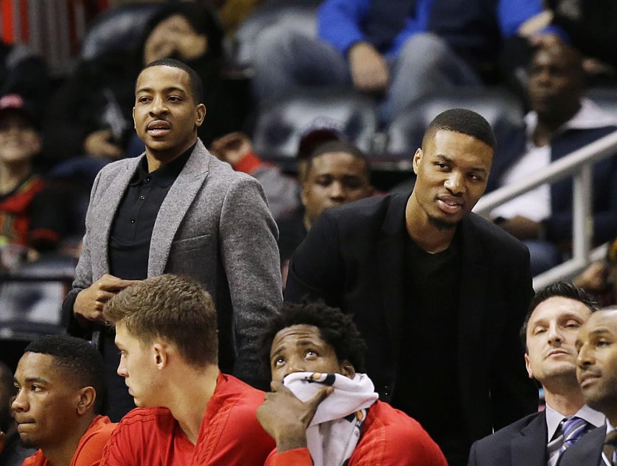 Portland Trail Blazers&#039; C.J. McCollum, left, and Damian Lillard watch from the bench during the first quarter of an NBA basketball game against the Atlanta Hawks Monday, Dec. 21, 2015, in Atlanta. Leading scorers Lillard and McCollum sat out for Monday night&#039;s game due to injuries. Lillard has plantar fasciitis in his left foot. McCollum has two sprained ankles.