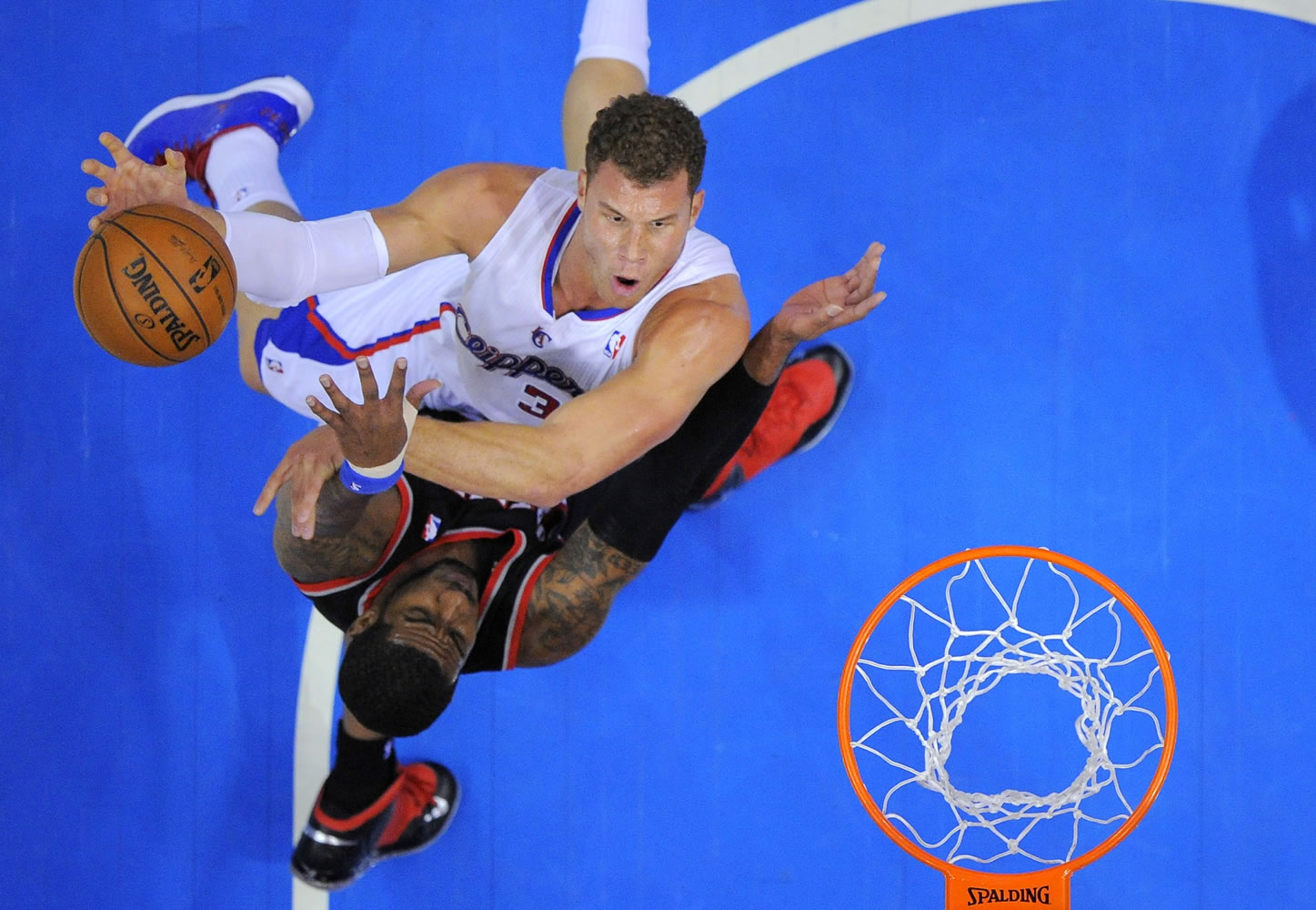 Los Angeles Clippers forward Blake Griffin, top, puts up a shot as Portland Trail Blazers forward LaMarcus Aldridge defends during the first half Sunday.