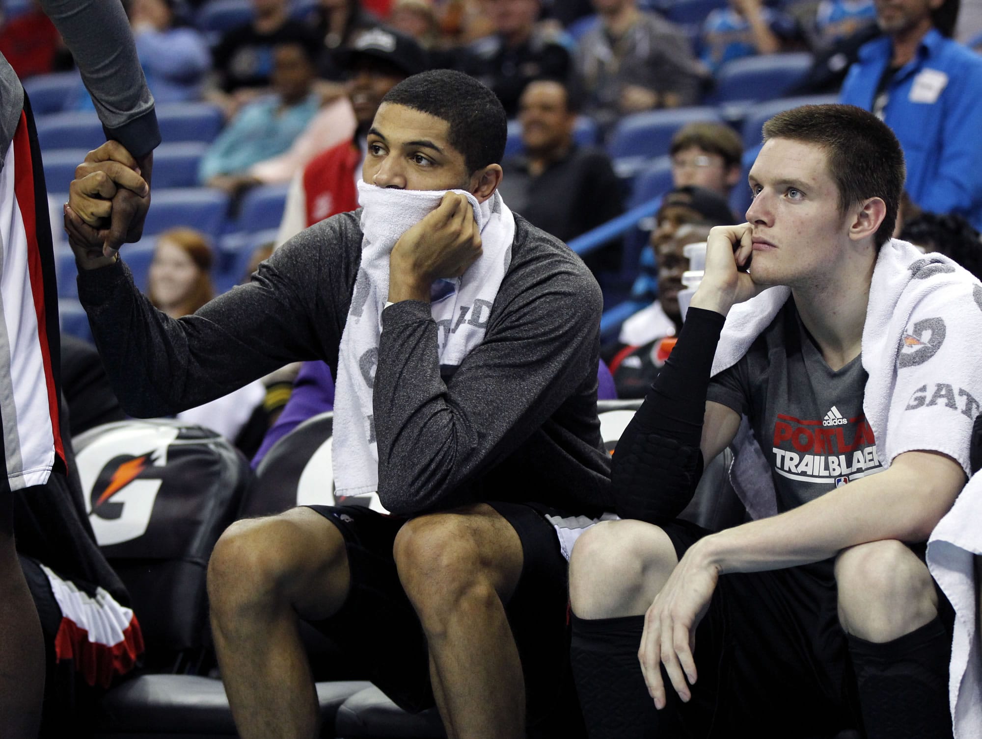 Nicolas Batum watches with forward Luke Babbitt, right, in the second half of an NBA basketball game against the New Orleans Hornets in New Orleans.
