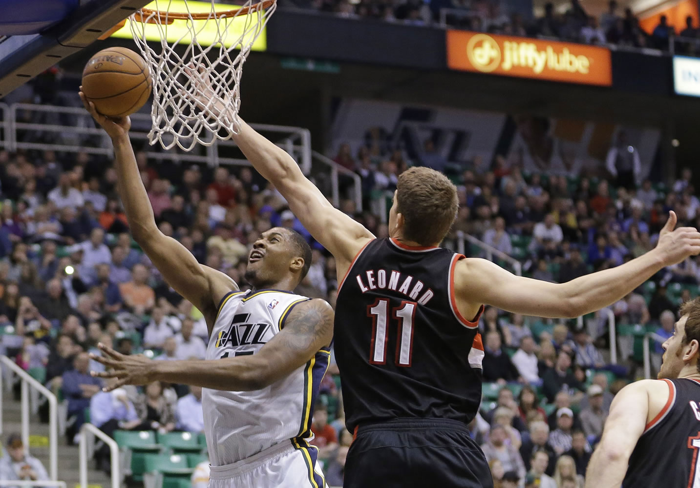 Utah's Derrick Favors (15) goes to the basket as Portland's Meyers Leonard (11) defends in the fourth quarter  Monday at Salt Lake City.