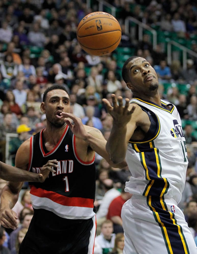 Utah Jazz forward Derrick Favors, right, looks to grab a rebound against Portland Trail Blazers forward Jared Jeffries (1) in the first half Friday.