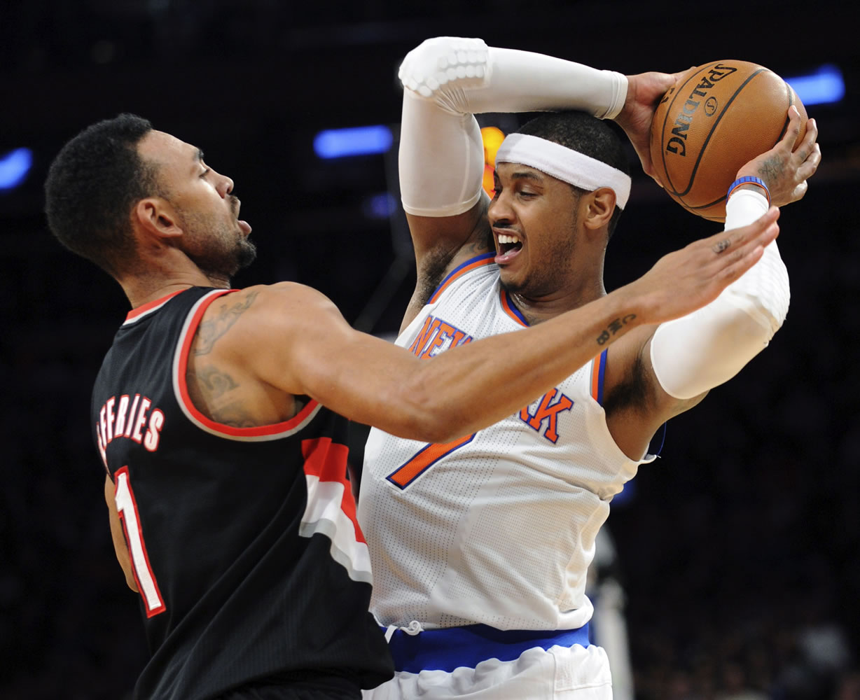 New York Knicks' Carmelo Anthony, right, is pressured by Portland Trail Blazers' Jared Jeffries during the second quarter Tuesday.