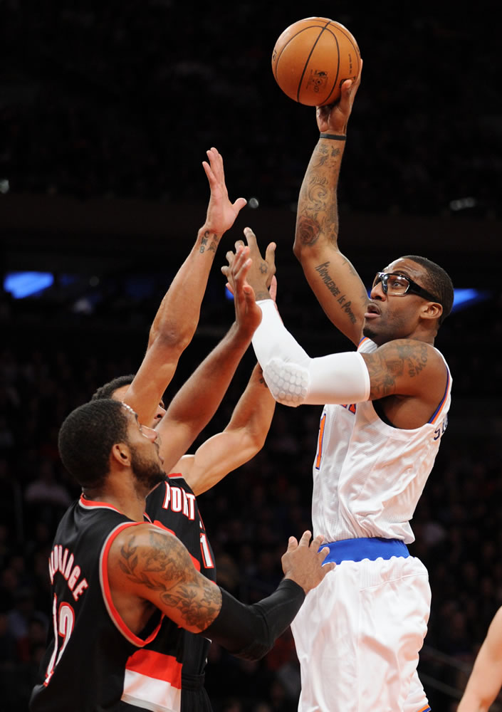 New York Knicks' Amare Stoudemire, right, shoots over Portland Trail Blazers' LaMarcus Aldridge and Jared Jeffries, rear, during the first quarter Tuesday.
