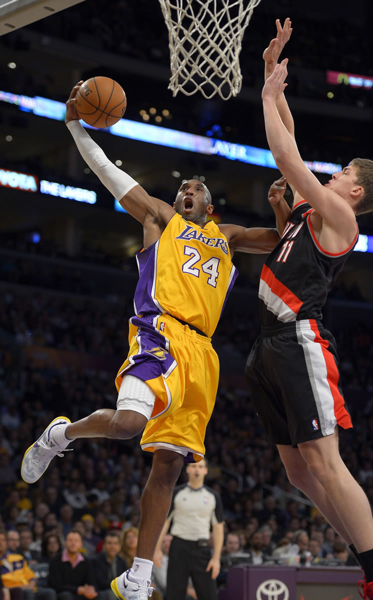 Los Angeles Lakers guard Kobe Bryant (24) goes up for a shot as Portland Trail Blazers center Meyers Leonard defends during the first half Friday.