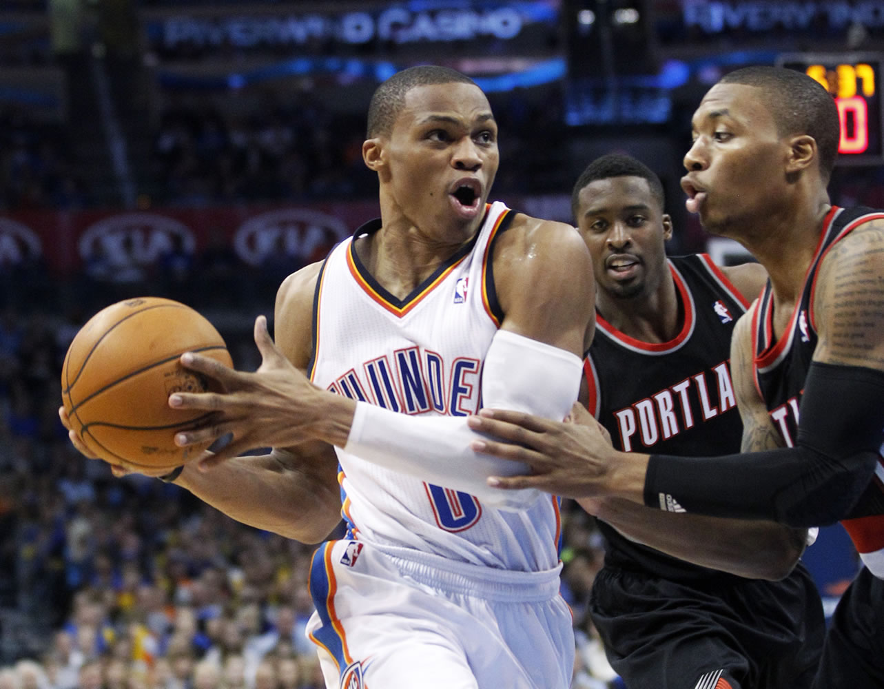 Oklahoma City Thunder guard Russell Westbrook (0) drives past Portland Trail Blazers guard Damian Lillard, right, during the fourth quarter Friday.
