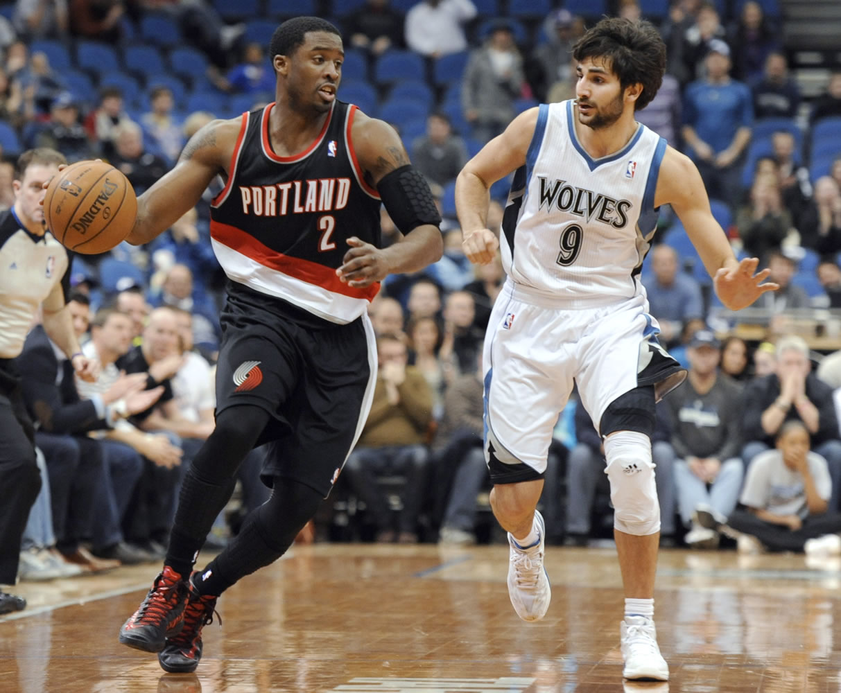 Portland Trail Blazers' Wesley Matthews (2) moves the ball alongside Minnesota Timberwolves' Ricky Rubio (9), of Spain, during the fourth quarter of an NBA basketball game Monday, Feb. 4, 2013, in Minneapolis. The Trail Blazers won 100-98.