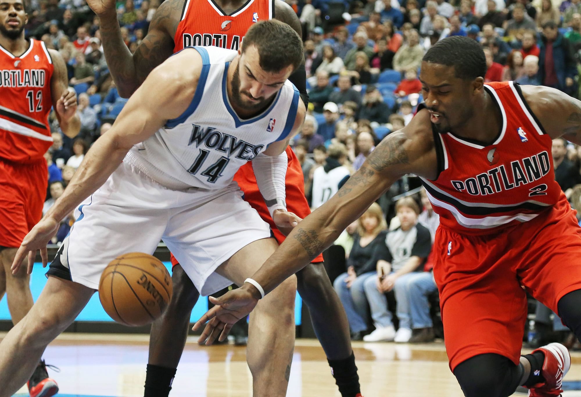 Portland Trail Blazers' Wesley Matthews, right, and Minnesota Timberwolves' Nikola Pekovic, go for the loose ball in the first quarter Saturday.