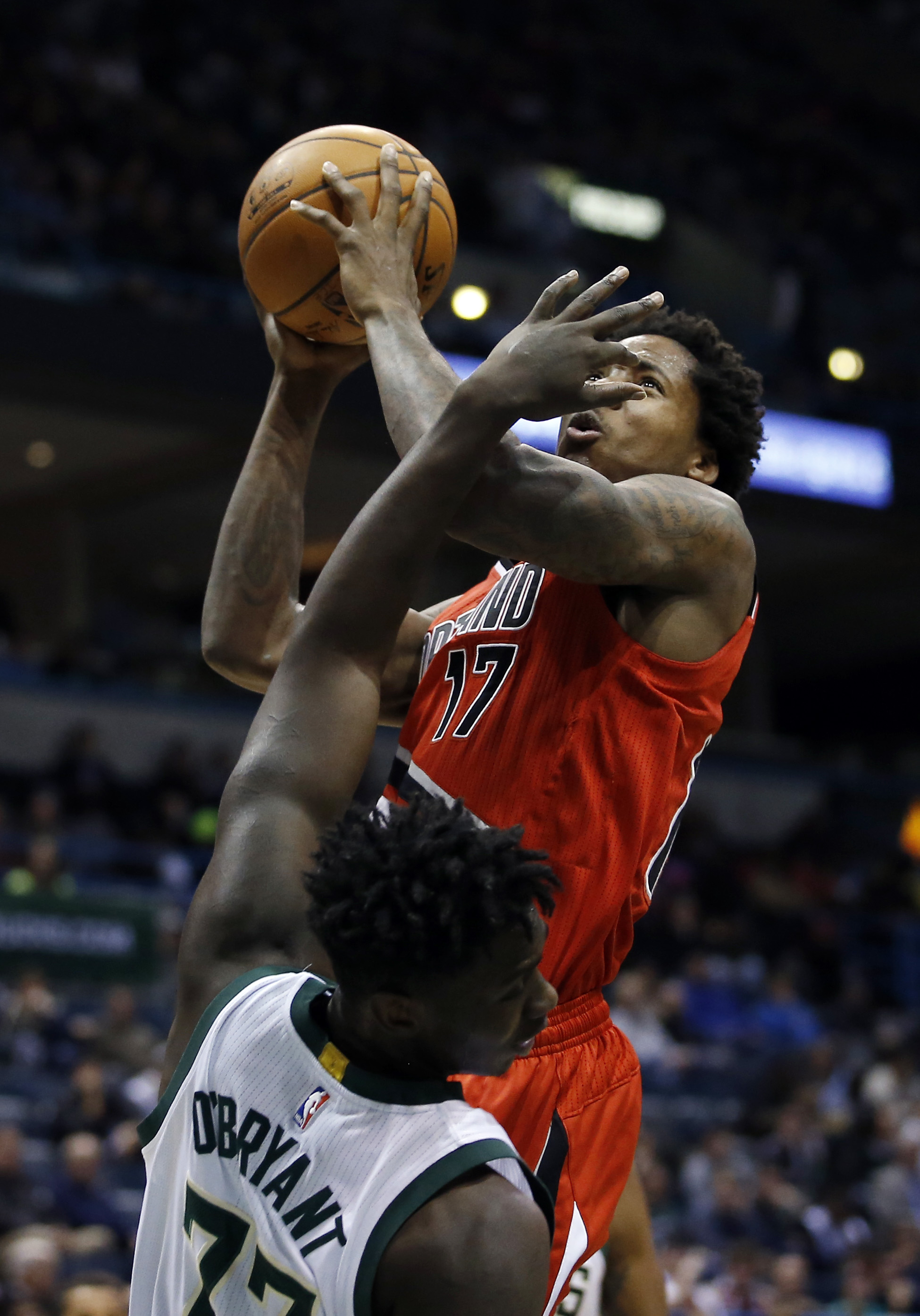 Portland Trail Blazers' Ed Davis (17) is fouled by Milwaukee Bucks' Johnny O'Bryant III as he shoots during the first half of an NBA basketball game Monday, Dec. 7, 2015, in Milwaukee.