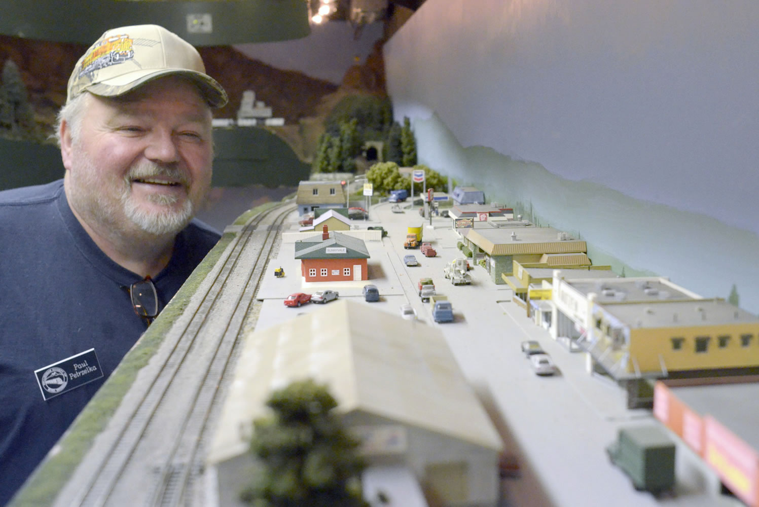 Paul Petrzelka examines a model railroad street scene.