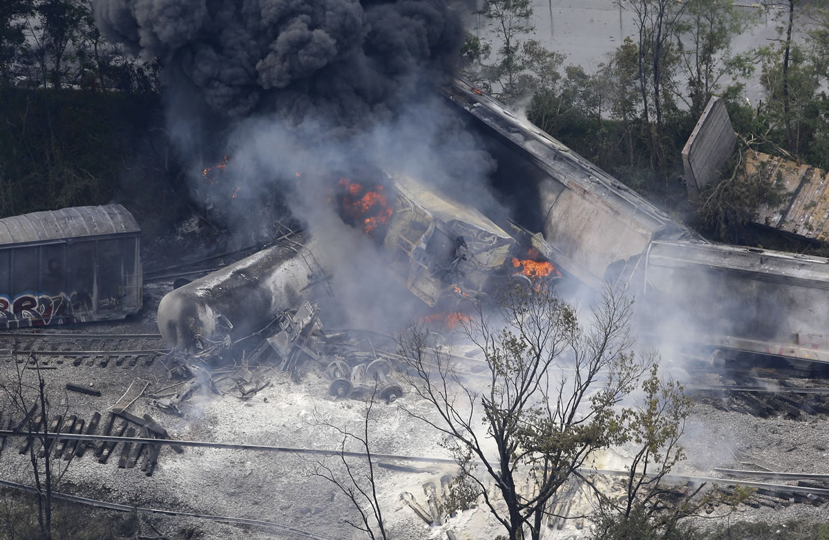 A fire burns at the site of a CSX freight train derailment Tuesday Rosedale, Md., where fire officials say the train crashed into a trash truck, causing an explosion that rattled homes at least a half-mile away and collapsed nearby buildings, setting them on fire.