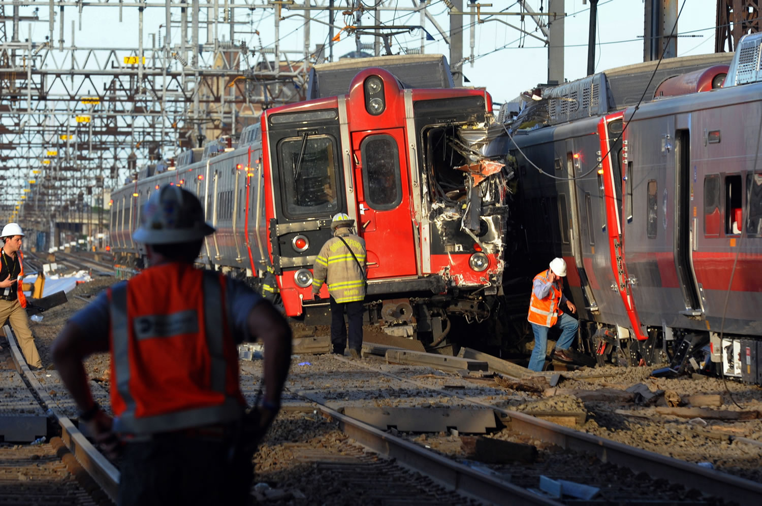 Emergency personnel work at the scene where two Metro North commuter trains collided Friday near Fairfield, Conn. Bill Kaempffer, a spokesman for Bridgeport public safety, told The Associated Press approximately 49 people were injured, including four with serious injuries.