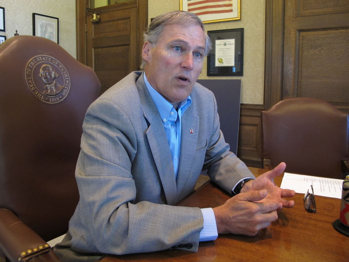 Gov. Jay Inslee speaks to reporters about hopes for a compromise on a transportation revenue package on Saturday in Olympia.