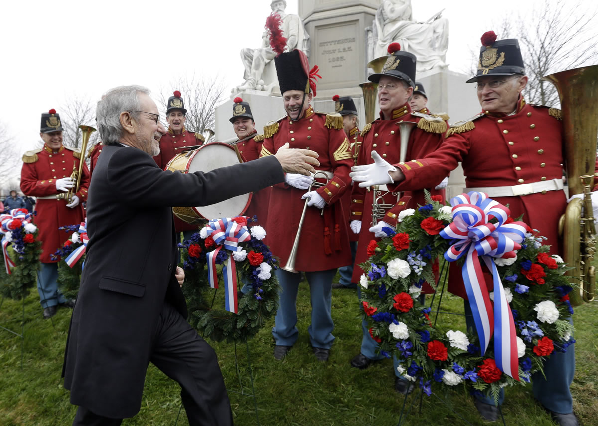Director Steven Spielberg, left, greets members of &quot;The President's Own Band,&quot; a musical group of Civil War re-enactors, during a ceremony to mark the 149th anniversary of President Abraham Lincoln's delivery of the Gettysburg Address at Soldier's National Cemetery in Gettysburg, Pa.