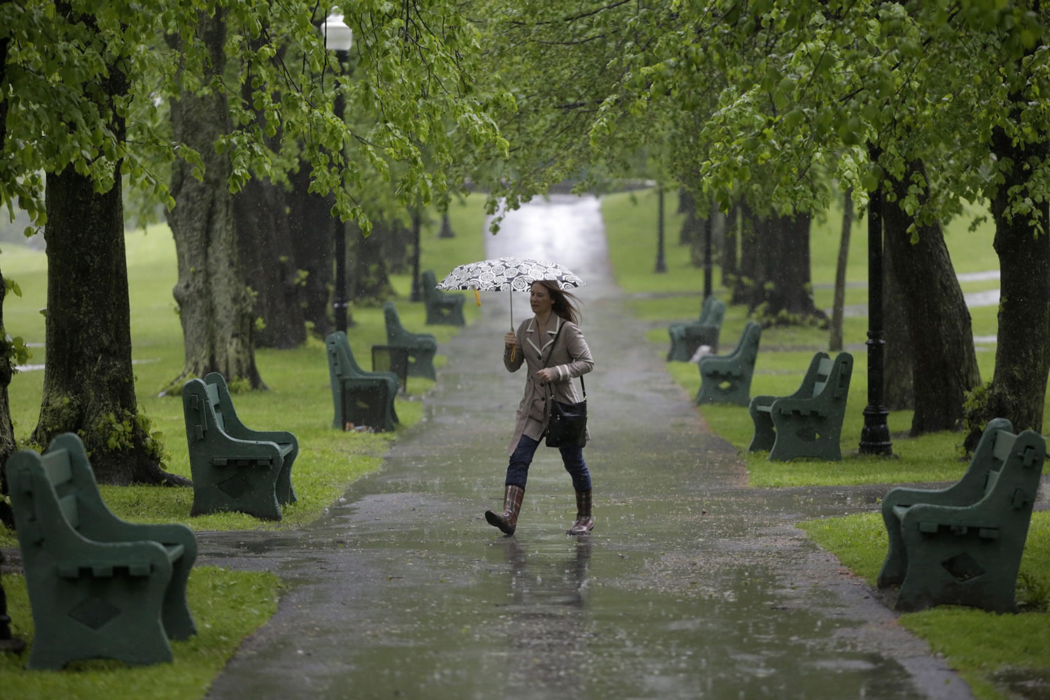 A pedestrian shields herself from the rain in downtown Halifax, Nova Scotia on Saturday.