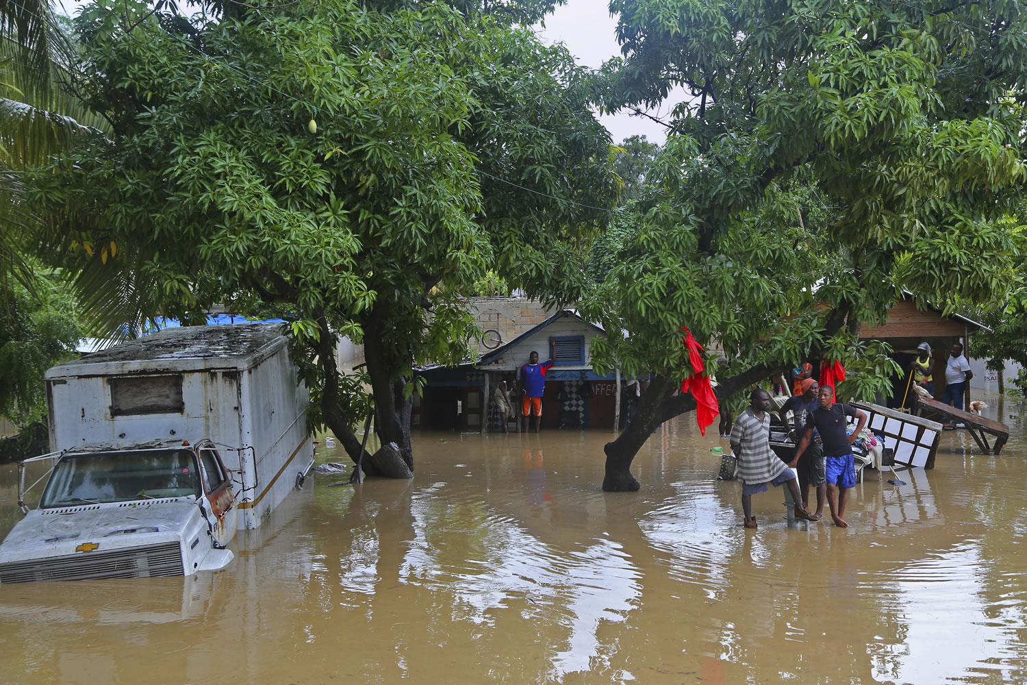 Residents of Leogane, Haiti find higher ground as the water level continues to rise Friday.