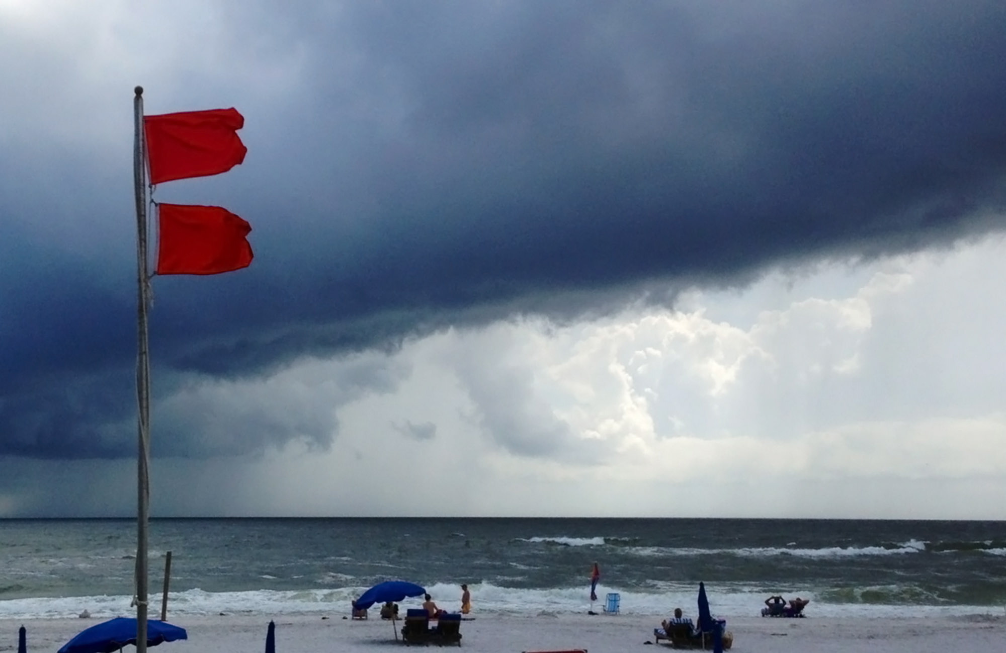 Red flags warn swimmers to stay out of the Gulf of Mexico as a squall from Tropical Storm Karen moves offshore at Gulf Shores, Ala., on Saturday.