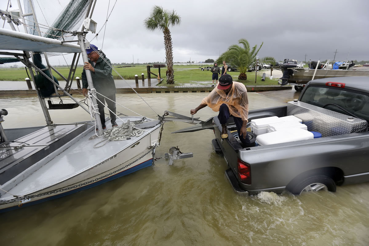 Tony Danos, left, and C.J. Johnson pull a shrimp boat out of the water, in anticipation of Tropical Storm Karen, at Myrtle Grove Marina in Plaquemines Parish, La., on Friday. National Hurricane Center forecasters expect Karen to be near the central Gulf Coast on Saturday as a weak hurricane or tropical storm. Along with strong winds, the storm was expected to produce rainfall of 3 to 6 inches through Sunday night, with isolated totals up to 10 inches possible.