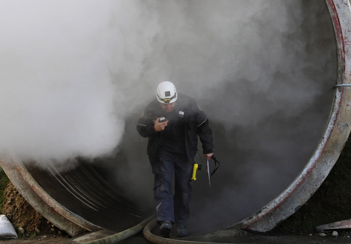 Seattle Battalion Chief Scott Yurczyk comes out of a tunnel during a practice exercise Wednesday.