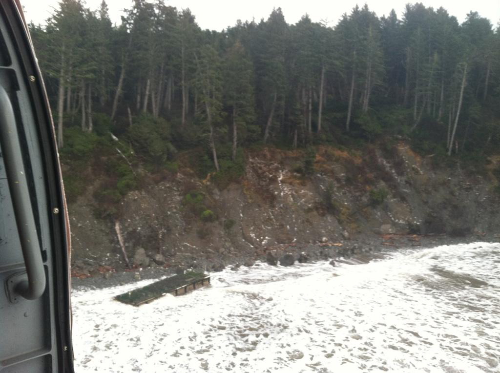 This image provided by the U.S. Coast Guard shows a large ocean-drifting dock that washed ashore in an extremely rugged and remote section of coast in the Olympic National Park Tuesday Dec. 18, 2012. It was found between LaPush and the mouth of the Hoh River.  The Coast Guard mounted a series of flights to locate the dock after it was spotted adrift in the ocean last Friday by fishermen aboard Fishing Vessel Lady Nancy.  The National Oceanic and Atmospheric Administration worked to determine the dockis trajectory based on the reported location at the time of the sighting. It has not been confirmed whether the dock is a piece of debris from the devastating March 2011 tsunami in Japan. (AP Photo/U.S.
